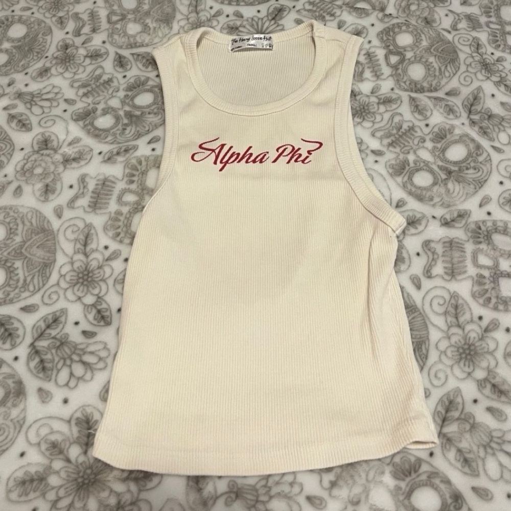 Creme Alpha Phi tank top with “Alpha Phi” in red